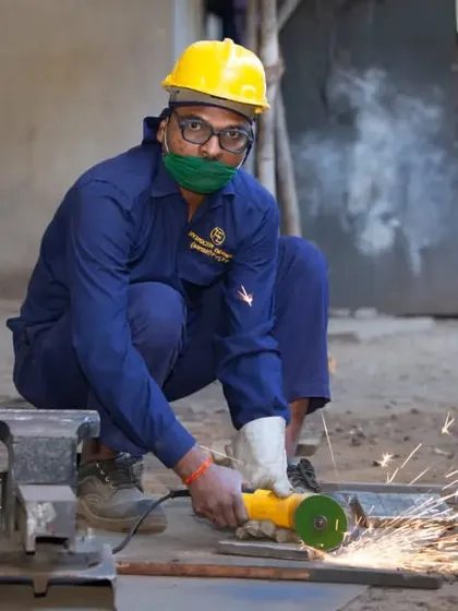 This action shot was taken during an industrial photography project at a manufacturing facility. Capturing the sparks from the angle grinder adds a dynamic element that documents the authentic, hands-on work happening on the factory floor.