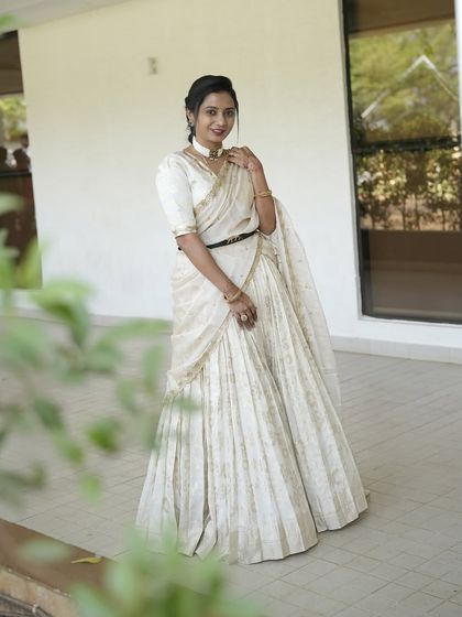 My dear friend Nithya shines in this custom-made light gold lehenga. I designed it with a modern, draped dupatta that can be belted at the waist, creating a look of effortless elegance for her special event.