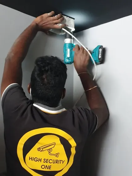 I am hands-on with every installation. Here I am fitting a dome camera, making sure the placement is perfect for the best security coverage.