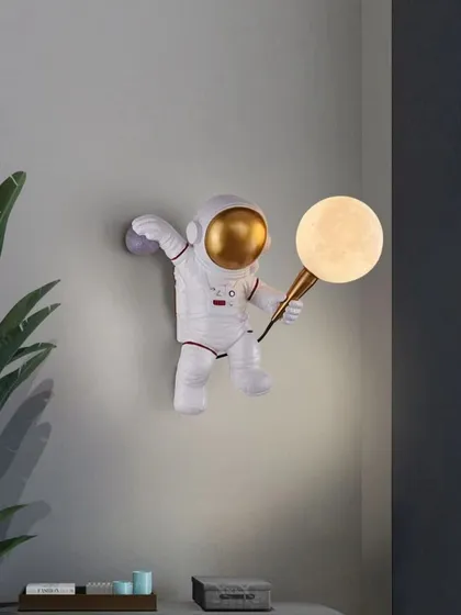 Bring a sense of wonder and exploration to a room with my astronaut wall light. The playful design features a spaceman holding a textured 'moon' globe that emits a soft, gentle light, perfect for a child's room or a creative study.