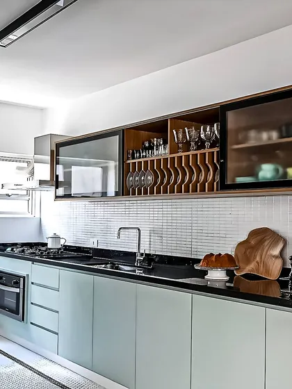 I believe great design is in the details. This custom overhead unit features specialized racks for wine glasses and plates, along with glass-front cabinets, turning everyday storage into a beautiful and organized display.