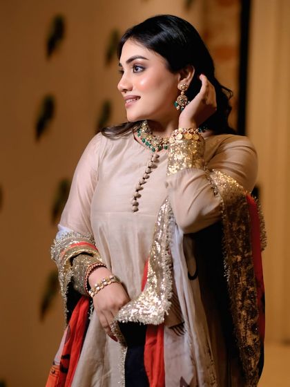 A candid, elegant shot of a model just before a show. This captures the quiet confidence and beauty of the moments leading up to the runway.