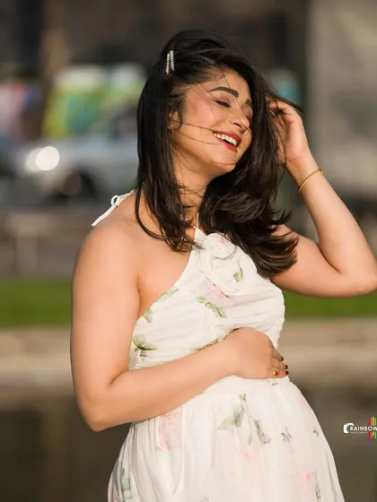 A close-up of Aditi's radiant smile during her outdoor maternity shoot, capturing the glow of impending motherhood.