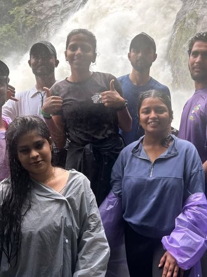 Our happy group posing in front of the mighty Dudhsagar falls. We ensure a safe and enjoyable experience for everyone, including solo female travelers.