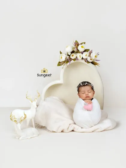 A slightly different angle of our white heart bowl setup, showing the beautiful details of the prop and the serene expression of the sleeping baby.