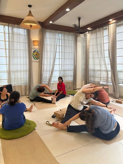 A group of students enjoying a partner stretch, working together to increase flexibility and release tension.