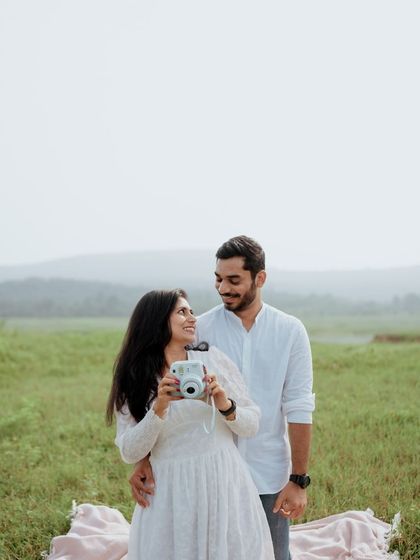 A sweet and simple portrait of a couple during their picnic-themed shoot, their smiles and closeness telling the whole story.