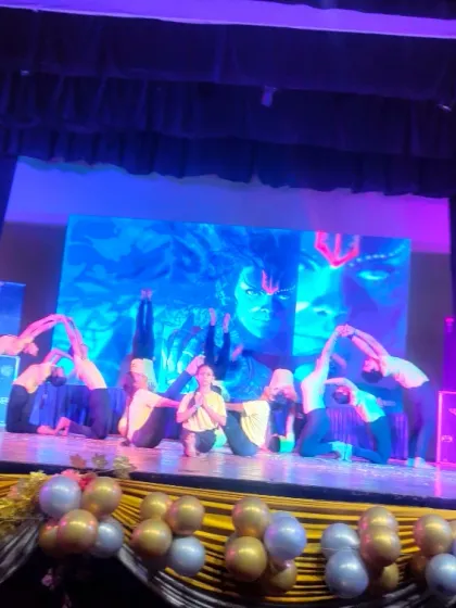 A creative formation by our students, blending elements of dance and advanced yoga. The back-lit stage at Shah Auditorium beautifully highlights their silhouettes.