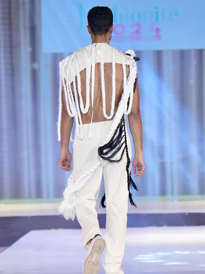 The back view of this unique runway creation, showing the detailed craftsmanship and unconventional design from all angles.
