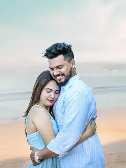 An intimate closeup from a beach pre-wedding shoot, focusing on the couple's happy and serene embrace.