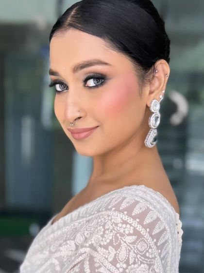 This client wanted a modern and chic look. I created a soft smokey eye with a sharp wing and paired it with glowing skin and a nude lip for a sophisticated finish.