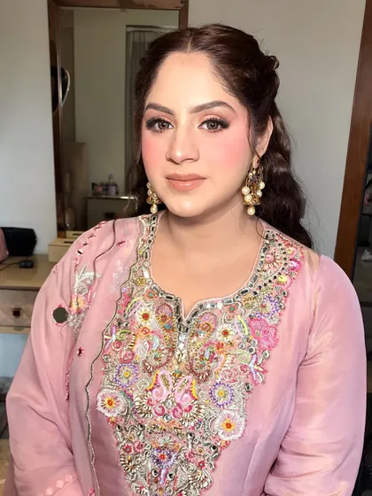 A close-up of the party makeup, highlighting the soft eye makeup and the beautiful, embroidered neckline.