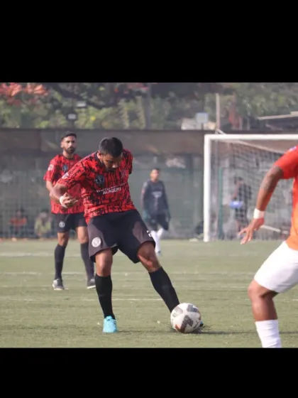 An attacker preparing to take a shot under pressure from a defender in the Republic Cup final.