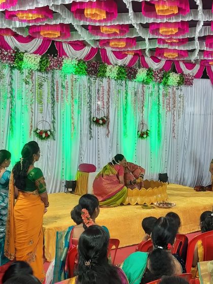 A beautiful moment from a Haldi ceremony, with the rituals taking place on a decorated stage. My green uplighting complements the traditional yellow and pink decor of the pandal.