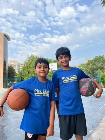 Two teammates and friends, ready for practice. The bonds formed on the court are just as important as the skills learned, and we encourage a strong sense of camaraderie.