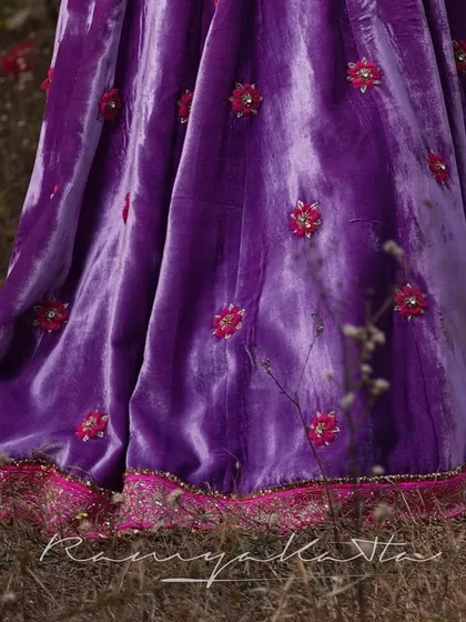 Detail of the lavender velvet skirt, showcasing the scattered 3D floral embroidery and the intricately embroidered zardosi border.