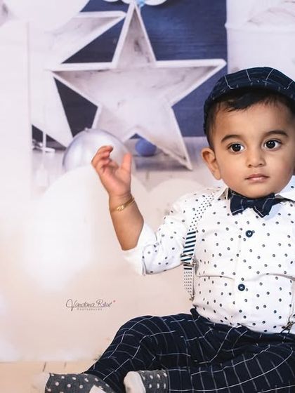 A full view of our starry night birthday theme. This backdrop is complete with balloon clouds, star props, and a number "1" sign, offering a comprehensive and magical setting for a first birthday.