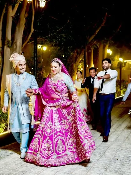 The couple walks with their friends, creating a candid and lively group shot.
