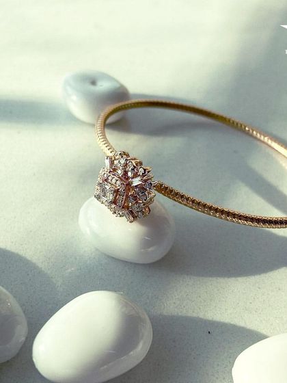 This minimalist gold bracelet with a central diamond cluster is the perfect finishing touch. It uplifts any look, making you feel effortlessly chic.