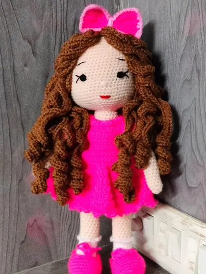 A full view of my curly haired doll in her bright pink dress. She is one of my most popular designs.