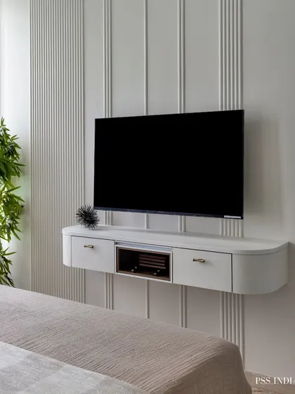 This floating TV console against a vertically paneled wall is a perfect example of modern, space-saving design. It keeps the room feeling open and uncluttered while providing necessary function.