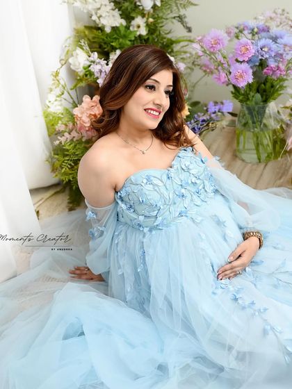 A close-up portrait glowing with happiness. Surrounded by fresh flowers, the mom-to-be's joyful smile is the highlight of this bright and beautiful shot.