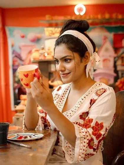 Find your focus and let your creativity flow. Here, a guest is adding personal touches to her ceramic cup, turning a simple object into a piece of her own story.