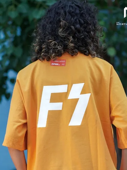 This orange tee from Flypside features a bold 'FS' graphic on the back. The design is clean, modern, and instantly recognizable.