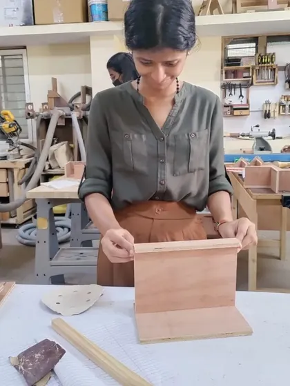 A student carefully assembling her project. These workshops are all about learning by doing, and turning a 2D drawing into a 3D object.