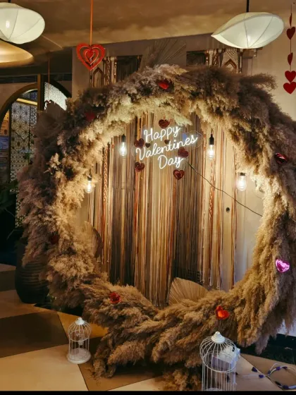 A rustic and romantic 'Happy Valentines Day' backdrop. I used a large ring frame covered in pampas grass with hanging lights for a warm, boho vibe.