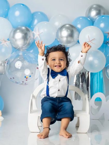 Hands up if you're one year old. This shot captures the pure excitement and energy of a first birthday celebration.