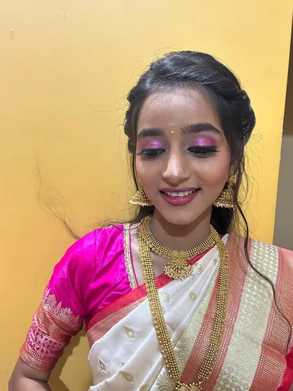 A close-up of the eye makeup, featuring soft pink tones that complement the saree perfectly. The look is fresh, youthful, and radiant.