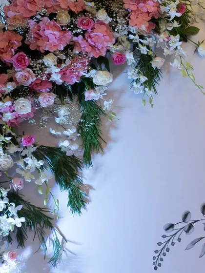 The art of floral design. This detailed shot showcases the beautiful combination of pink and white flowers used to create the stunning backdrop for the 78th birthday party.