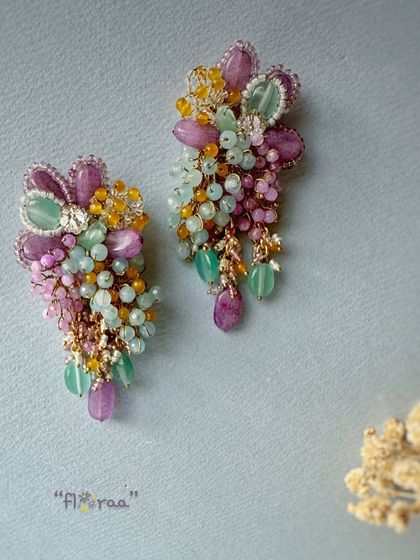 These gorgeous long earrings feature a vibrant mix of semi-precious stones, making them a versatile choice for Indian and fusion wear.