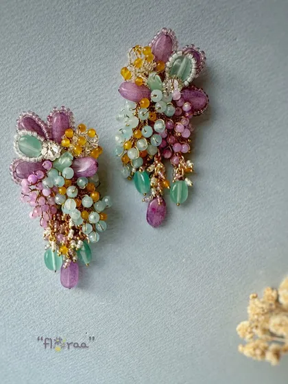 These gorgeous long earrings feature a vibrant mix of semi-precious stones, making them a versatile choice for Indian and fusion wear.