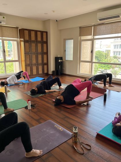 Together, we practice Setu Bandhasana, or Bridge Pose. This asana is excellent for strengthening the pelvic floor, glutes, and back, which provides essential support as your belly grows.