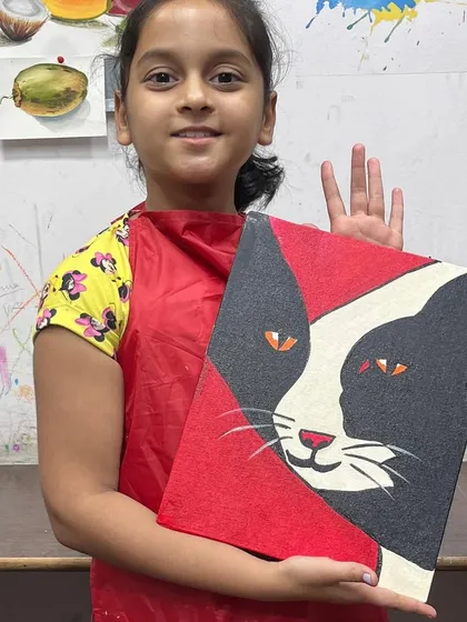 This student is thrilled with her bold, graphic cat painting. We encourage kids to experiment with color and composition to express their own creative vision.