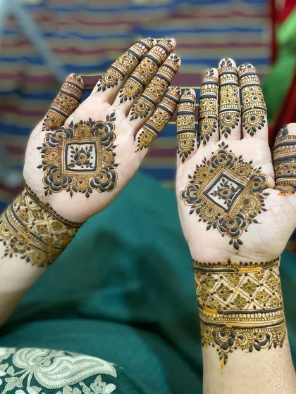 Another view of the geometric diamond design, showing how the patterns on both hands mirror each other perfectly.