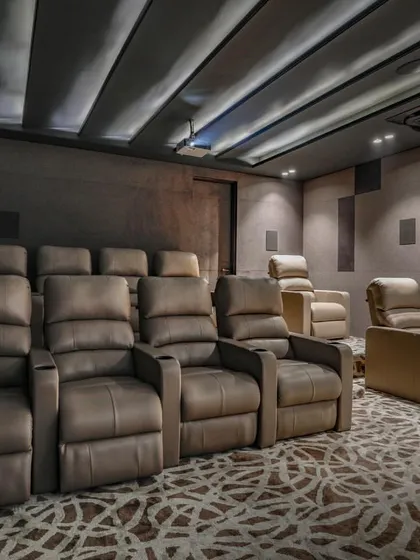 We designed this dedicated home theater for the ultimate cinematic experience. Featuring plush recliner seating, acoustically treated walls, and a professional-grade projection system, it’s a perfect example of a luxury specialty space.