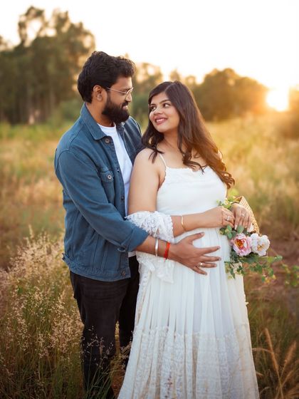 A sweet moment shared between the expecting couple. The soft sunlight and natural background make this a warm and genuine portrait of their journey together.