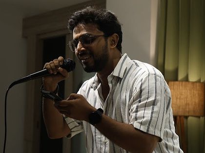 A singer enjoying the music as he performs for the crowd.