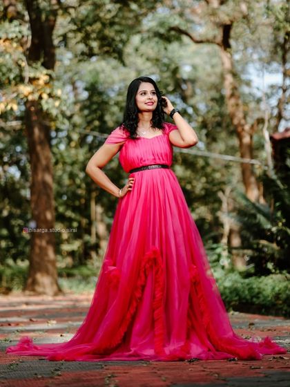A beautiful solo portrait of the bride-to-be in a magenta ruffled gown. It's a perfect dress for feeling like a princess on your pre-wedding shoot.