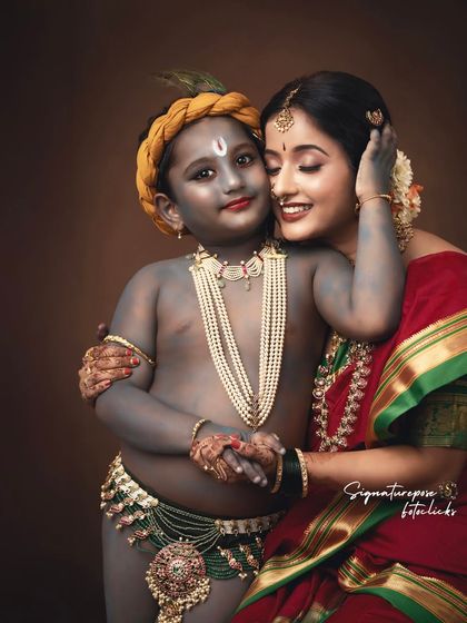 A close-up of a mother's loving embrace with her son dressed as Krishna, showcasing the intricate details of the styling and the genuine emotion of the moment.