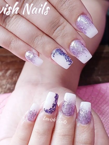 A white and purple glitter ombre design with a shattered glass effect on the accent nail.
