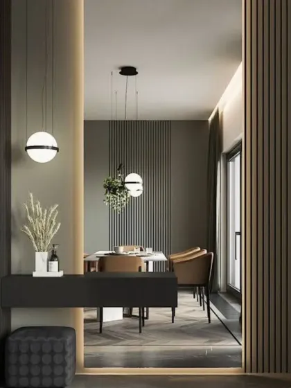 We use architectural details like fluted wall panels and creative lighting to define spaces. This entryway console and mirror create a welcoming and stylish first impression.