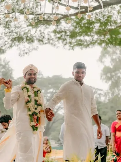 That just-married strut! This candid moment captures the couple's exit from the mandap, hand-in-hand with family, full of joy and tradition.