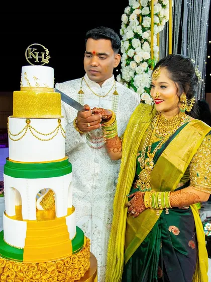 A beautiful photo of the couple cutting their cake, surrounded by family and friends.