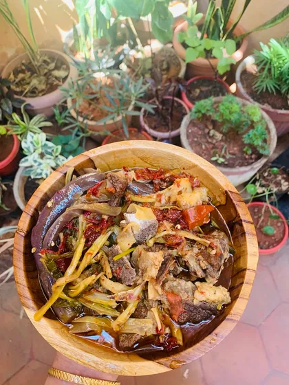 A wide shot of the beef bone soup, with my kitchen garden providing a fresh, green background.