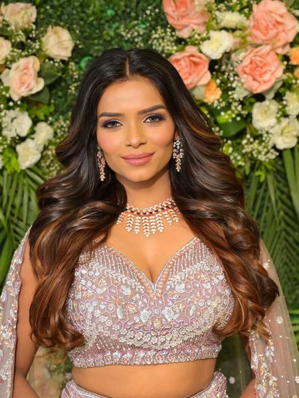 A confident and stunning bride. Her makeup is glamorous yet sophisticated, a perfect match for her modern reception outfit.