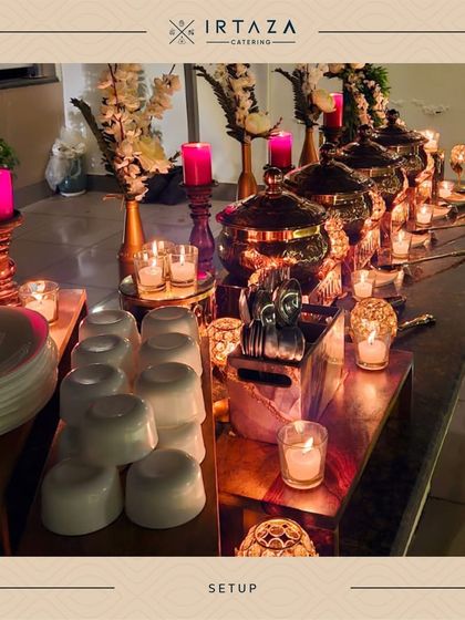 This setup features a beautiful mix of pink candles and ornate candle holders, adding a soft, romantic light to the dinner service.